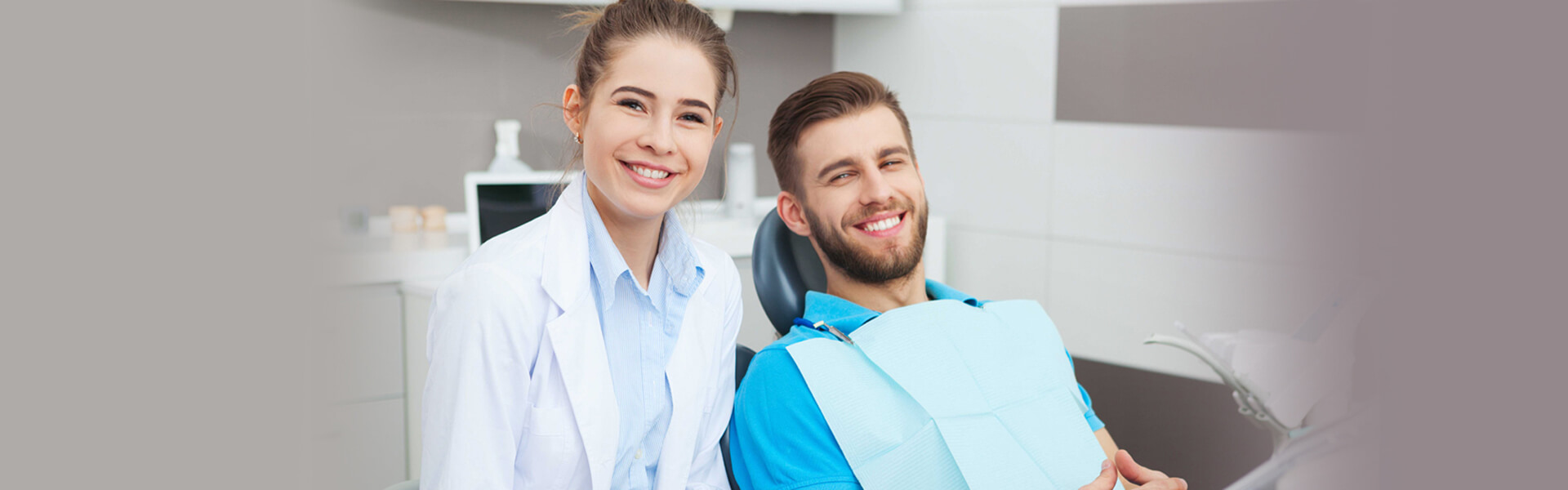 Dentist with smiling patient after dental exam and cleaning in Cambridge