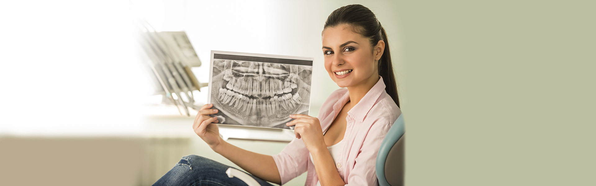 Dentist showing dental X-ray during exam in Cambridge clinic