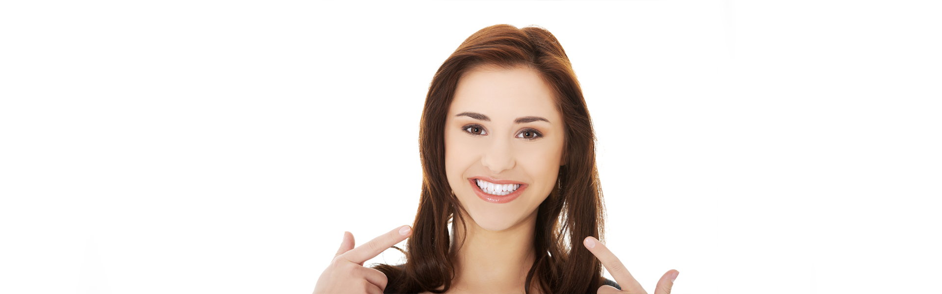 Smiling woman pointing at teeth after dental crown treatment in Cambridge