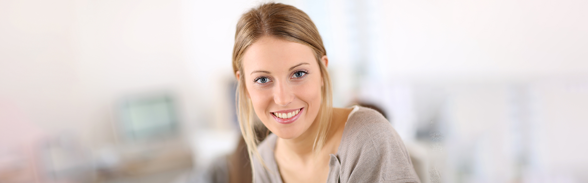 Smiling woman after receiving dental bridge treatment in Cambridge