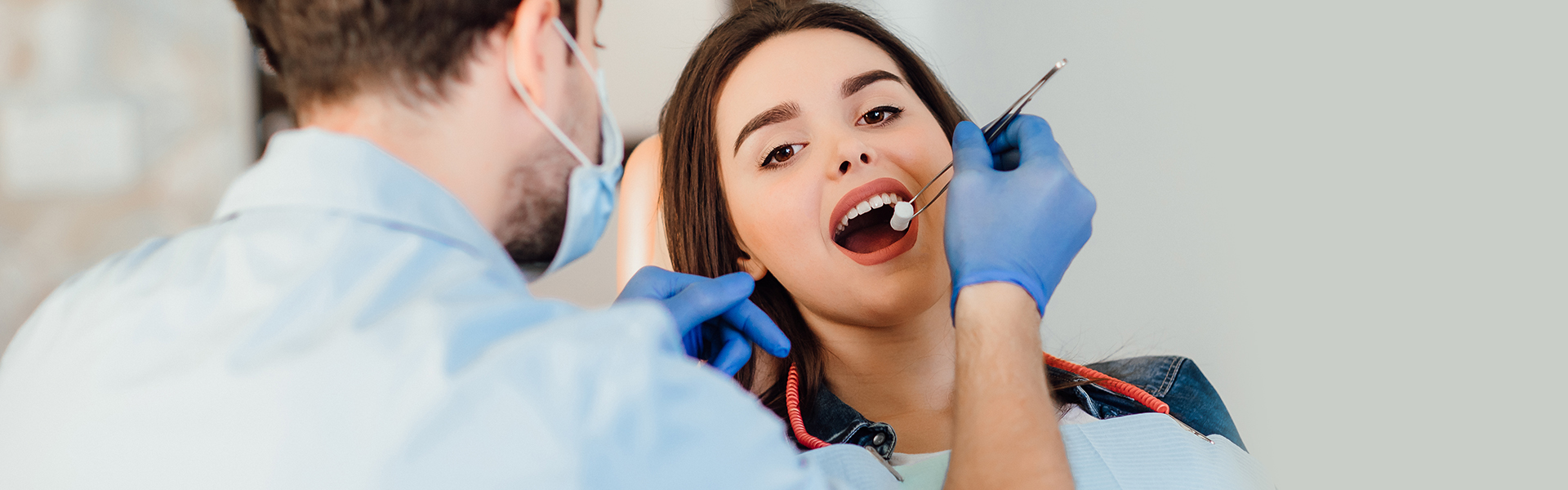 Dentist checking patient’s teeth during preventive dental exam in Cambridge