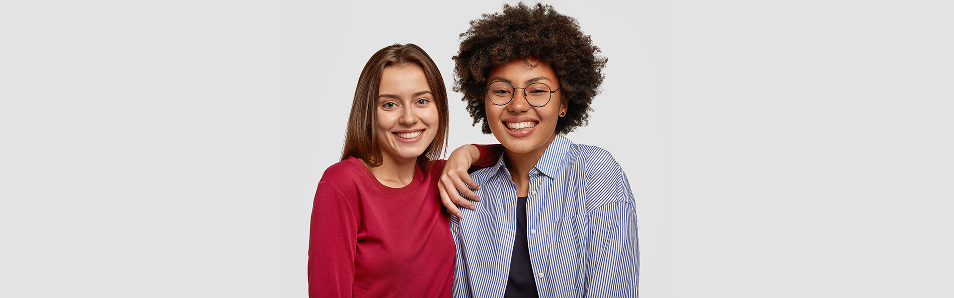 Two women smiling during a dental consultation in Cambridge