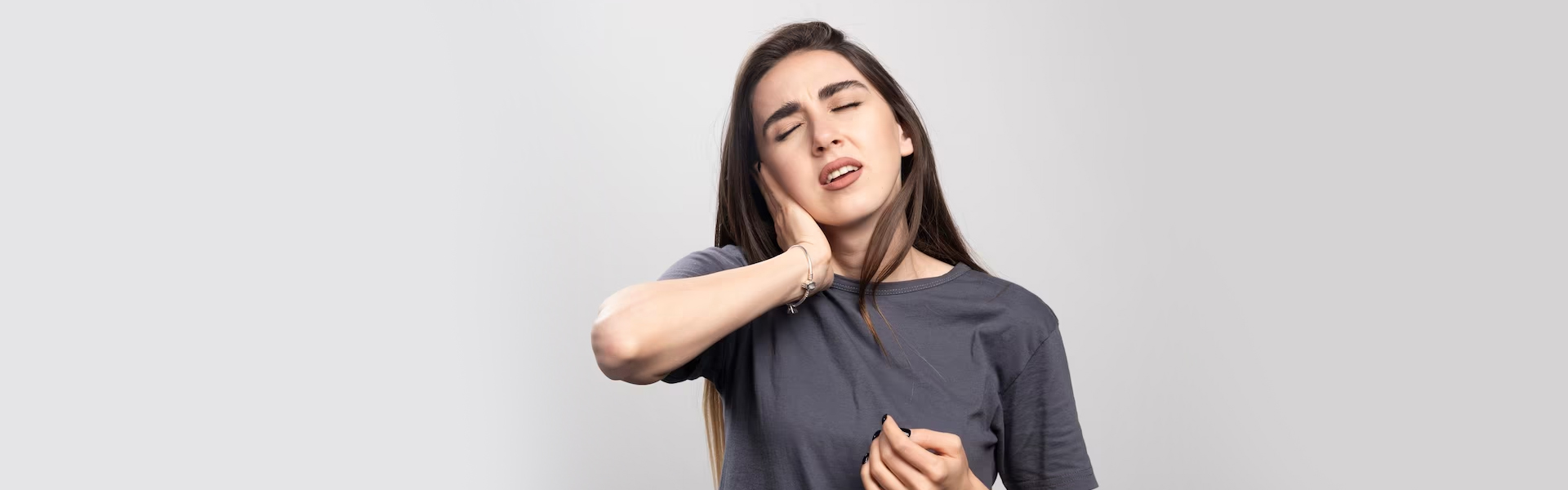Woman with tooth pain needing dental crown treatment in Cambridge