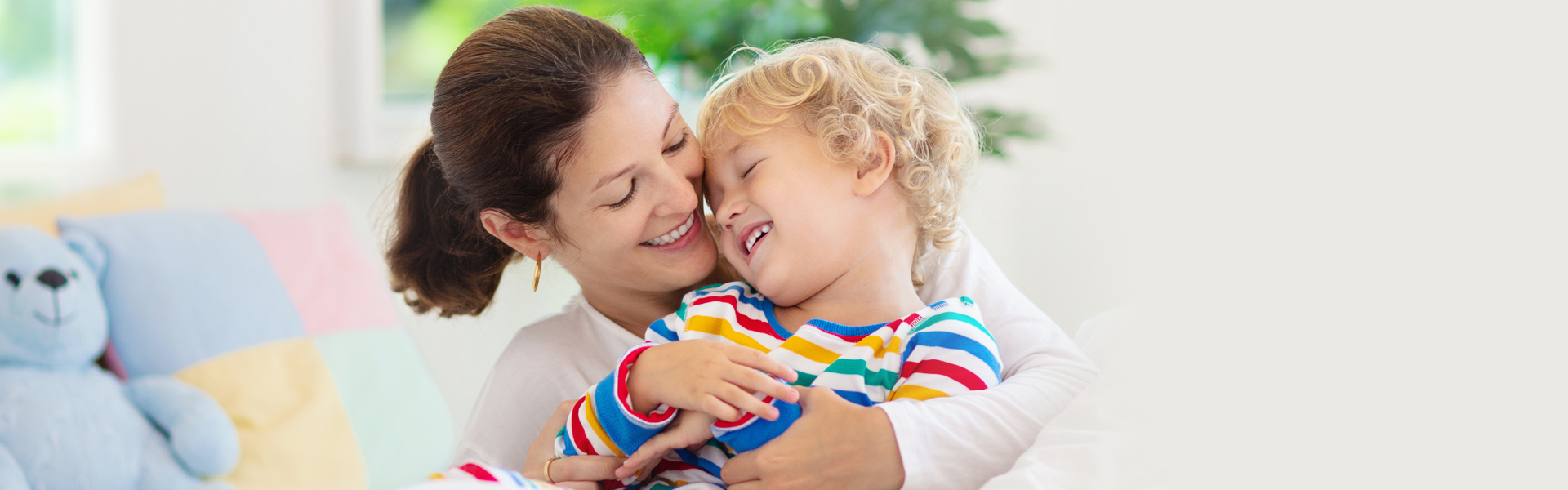 Mother hugging child and smiling during pediatric dental visit.