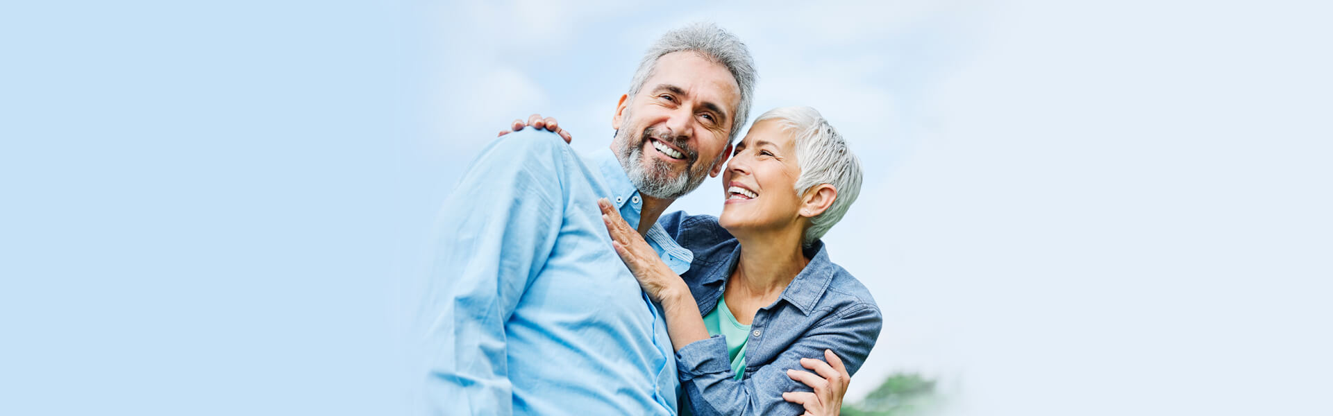 Happy senior couple smiling after preventive dental care.